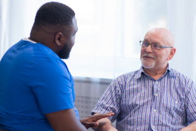 caregiver helping senior man